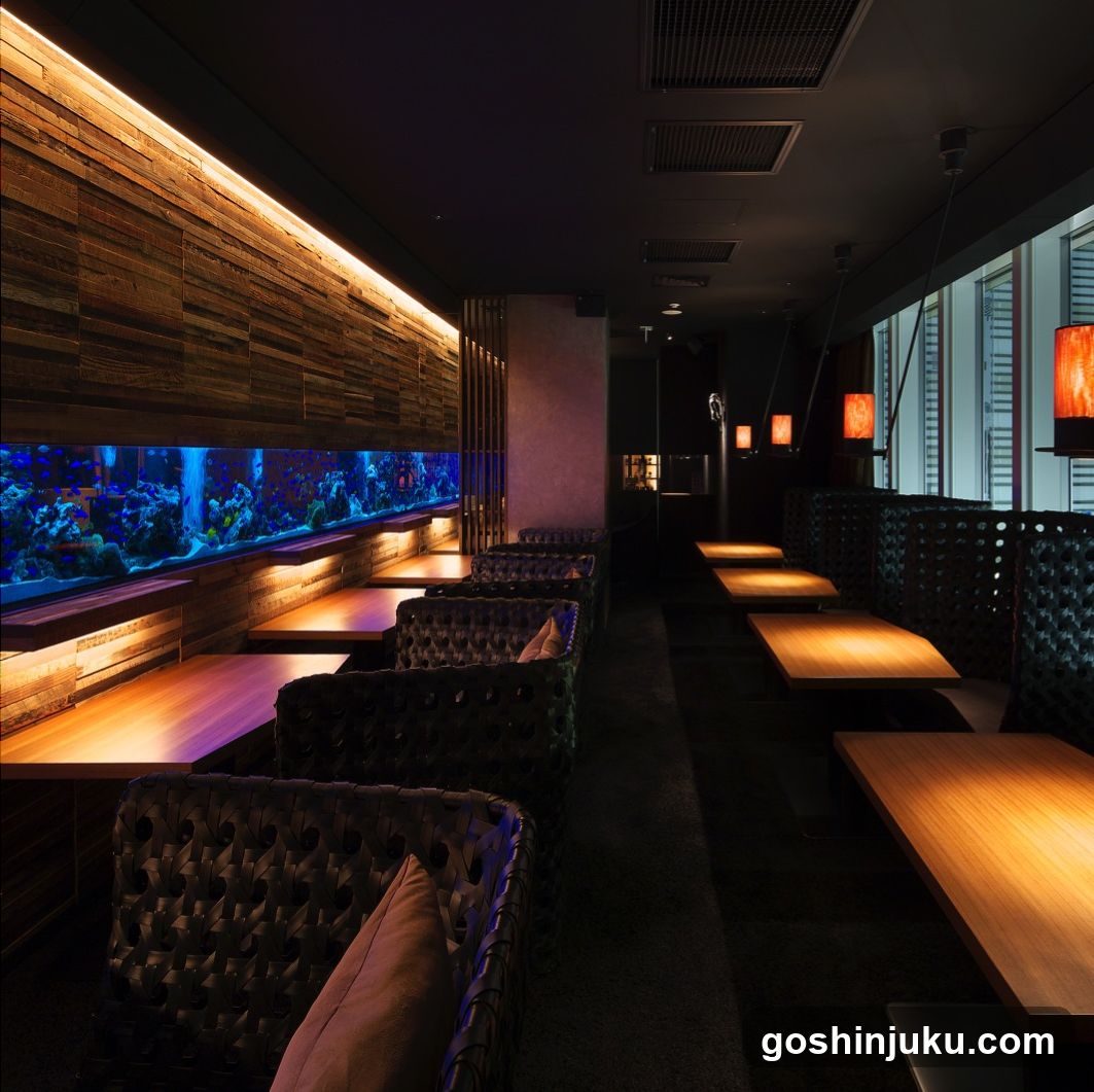 Interior of a dimly lit restaurant with aquarium wall