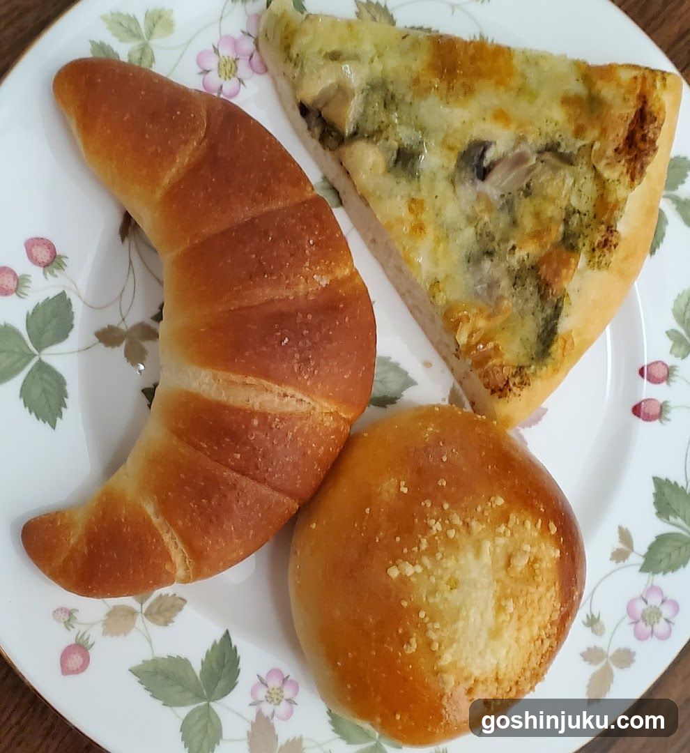 Breakfast Plate with Croissant, Pizza Slice, and Bun