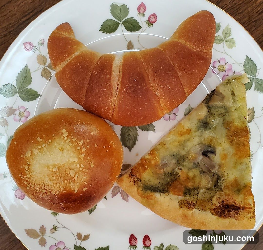 Breakfast Plate with Croissant, Bun, and Pizza Slice