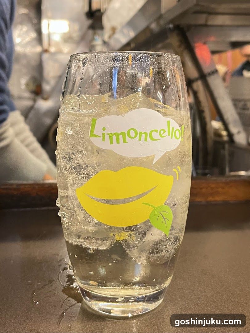 Limoncello drink in branded glass