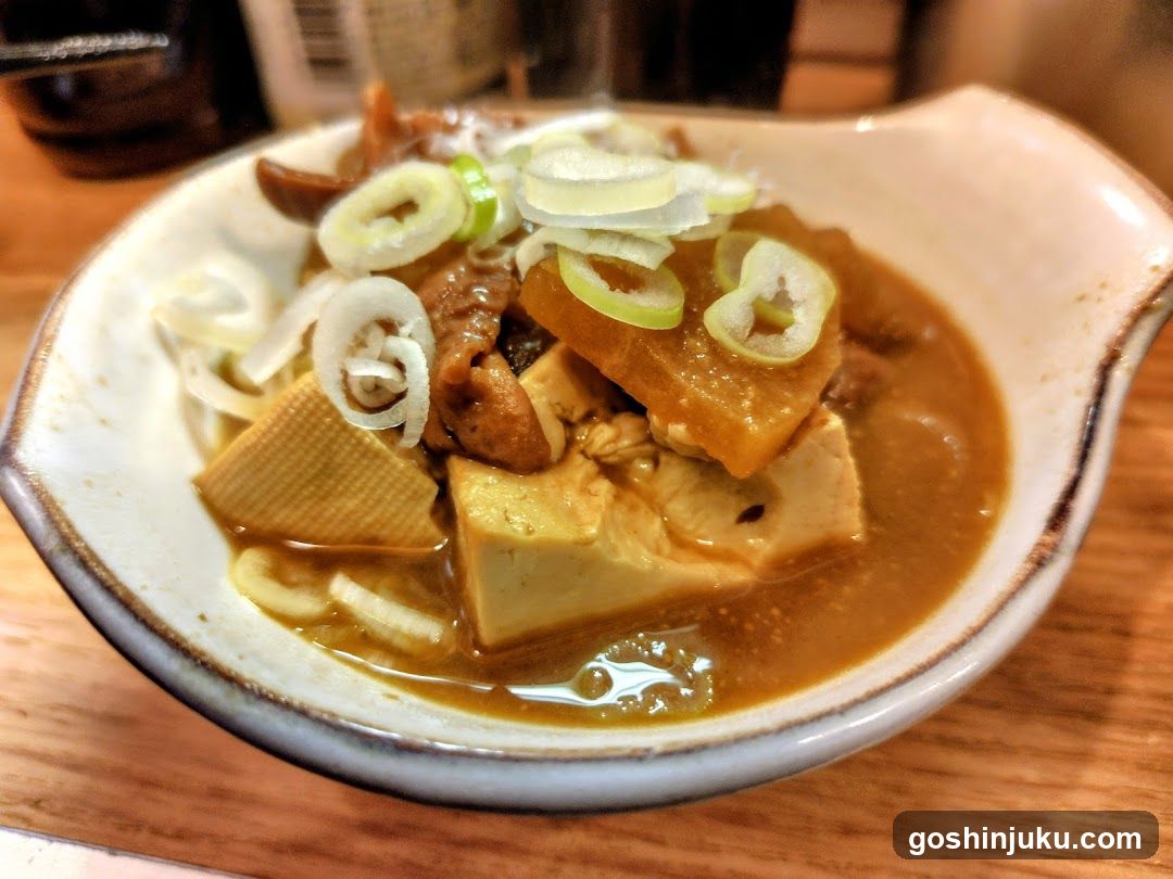 Cured Meat and Tofu Bowl with Green Onion Garnish