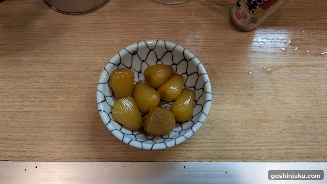 Bowl of pickled items on wooden table