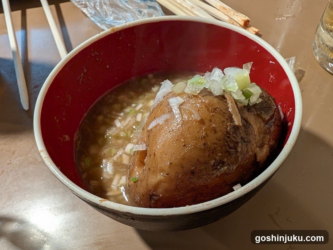 Bowl of Broth with Meatball and Onions