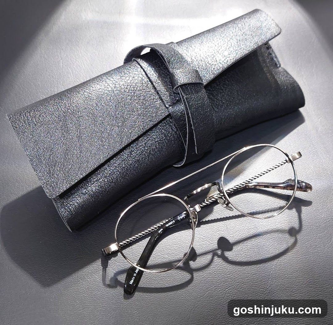Eyeglasses and Case on Leather Surface