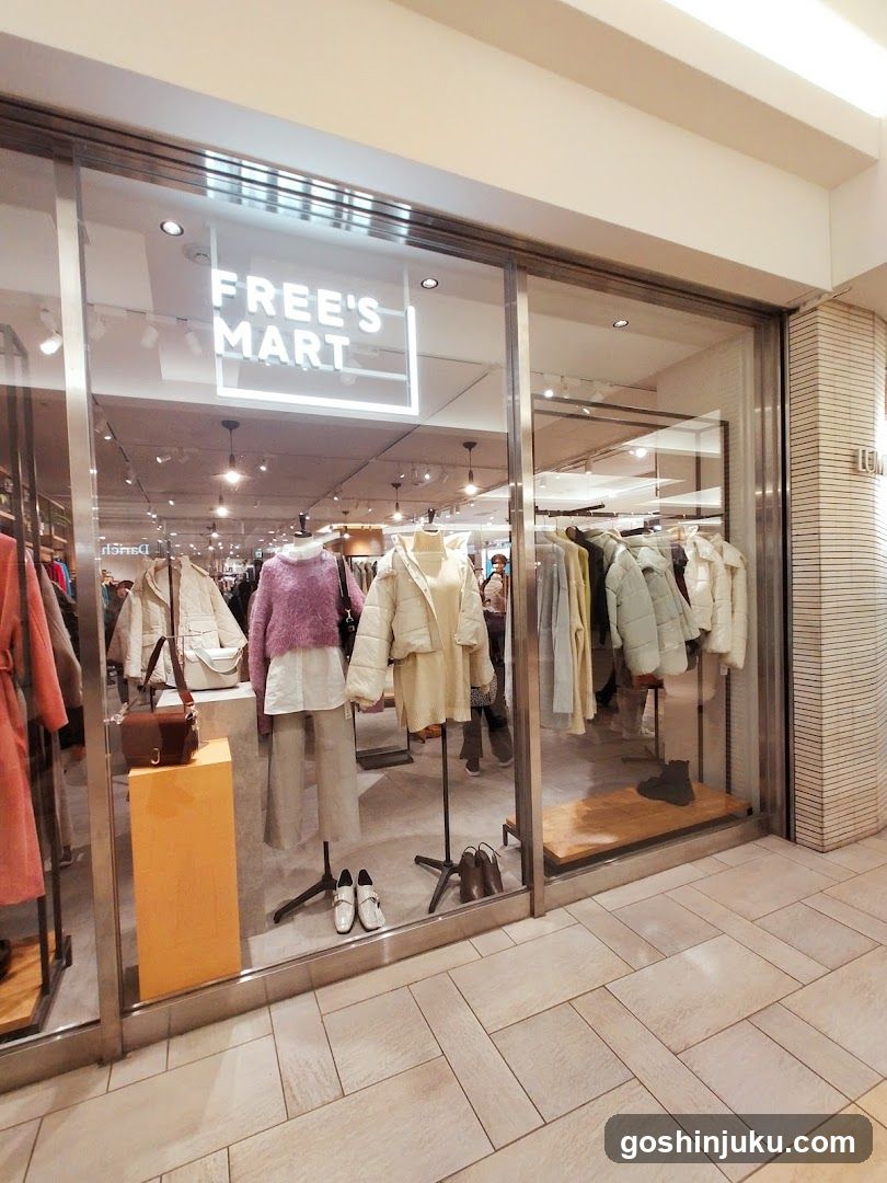 A clothing store with large glass windows displaying mannequins dressed in winter coats and accessories. The sign 'FREE'S MART' is visible above the entrance.