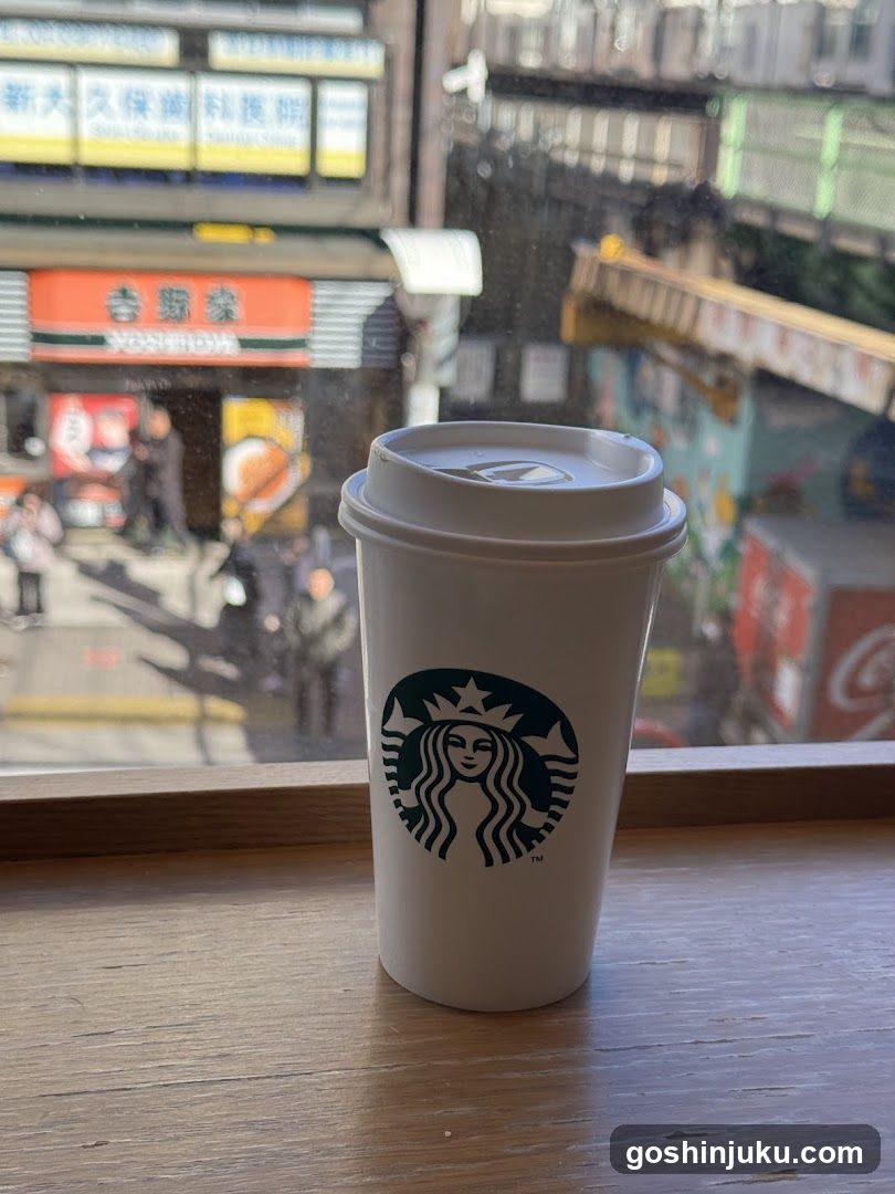 Starbucks cup on window sill