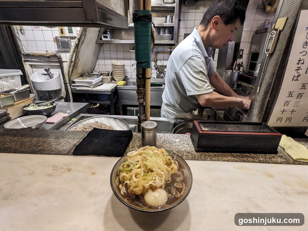 Ramen Shop Interior with Cook and Bowl of Ramen