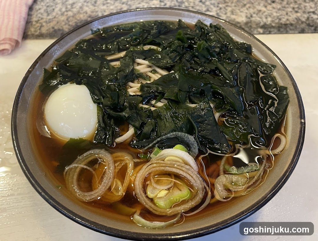 Bowl of Noodle Soup with Egg and Greens