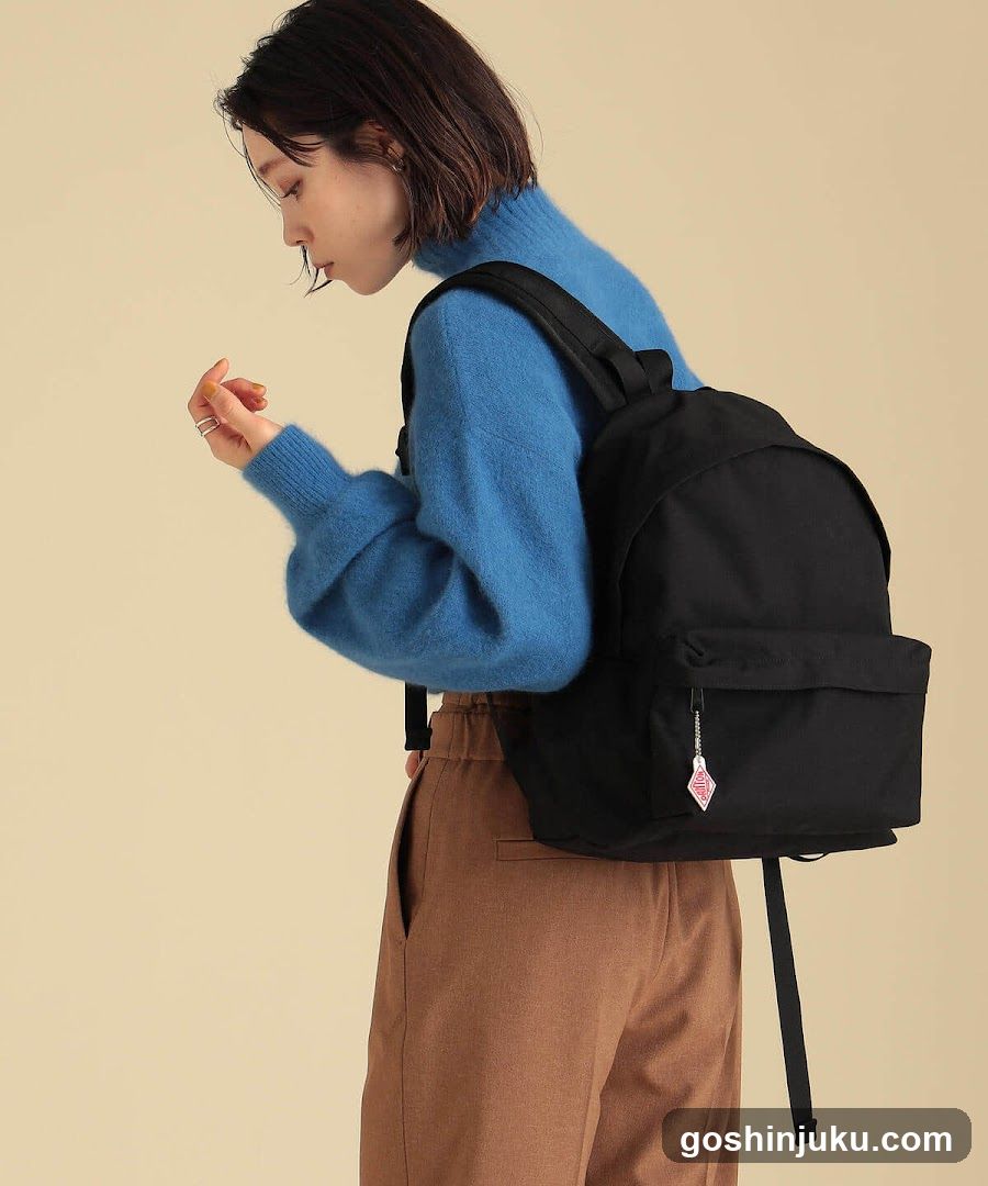 Woman with Blue Sweater and Black Backpack