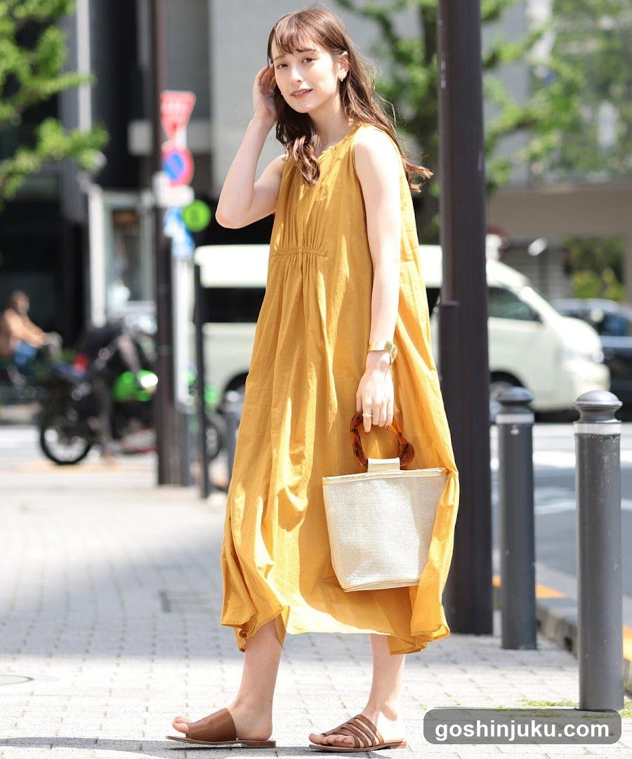 Woman in yellow dress on street