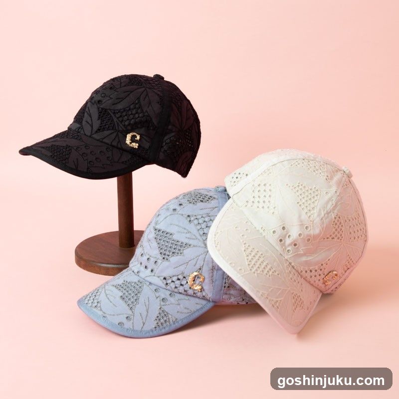Three Embroidered Baseball Caps Displayed on Pink Background