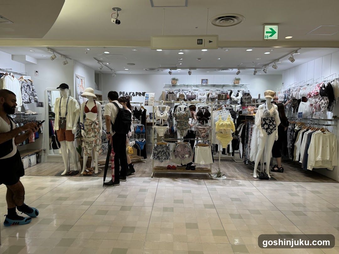 Interior of a clothing store with mannequins and shoppers