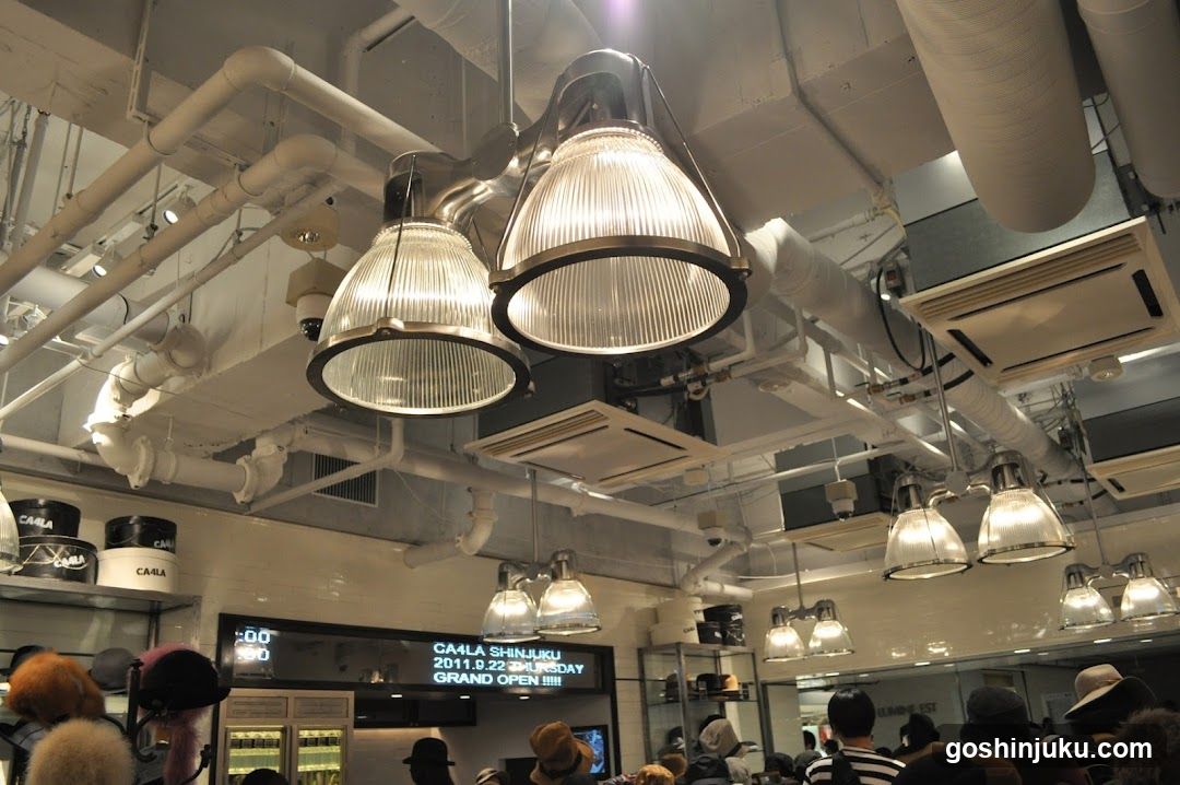 Interior of a cafe with industrial lighting and crowd