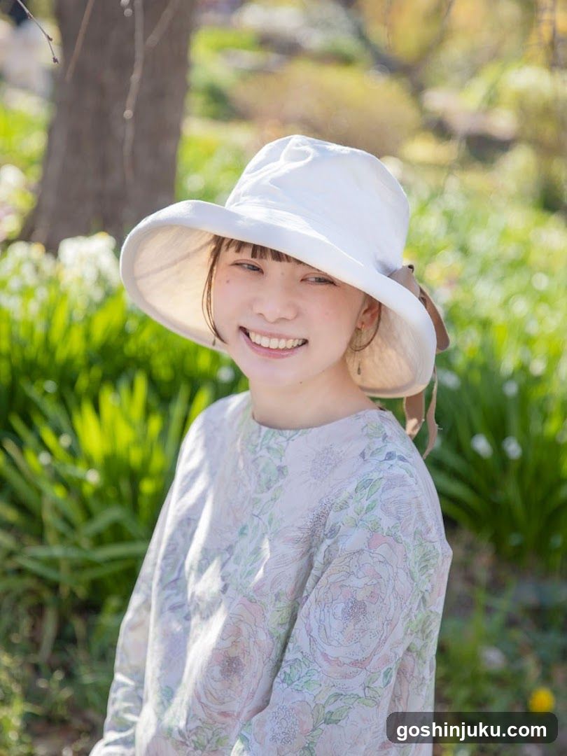 Girl in White Hat Smiling Outdoors