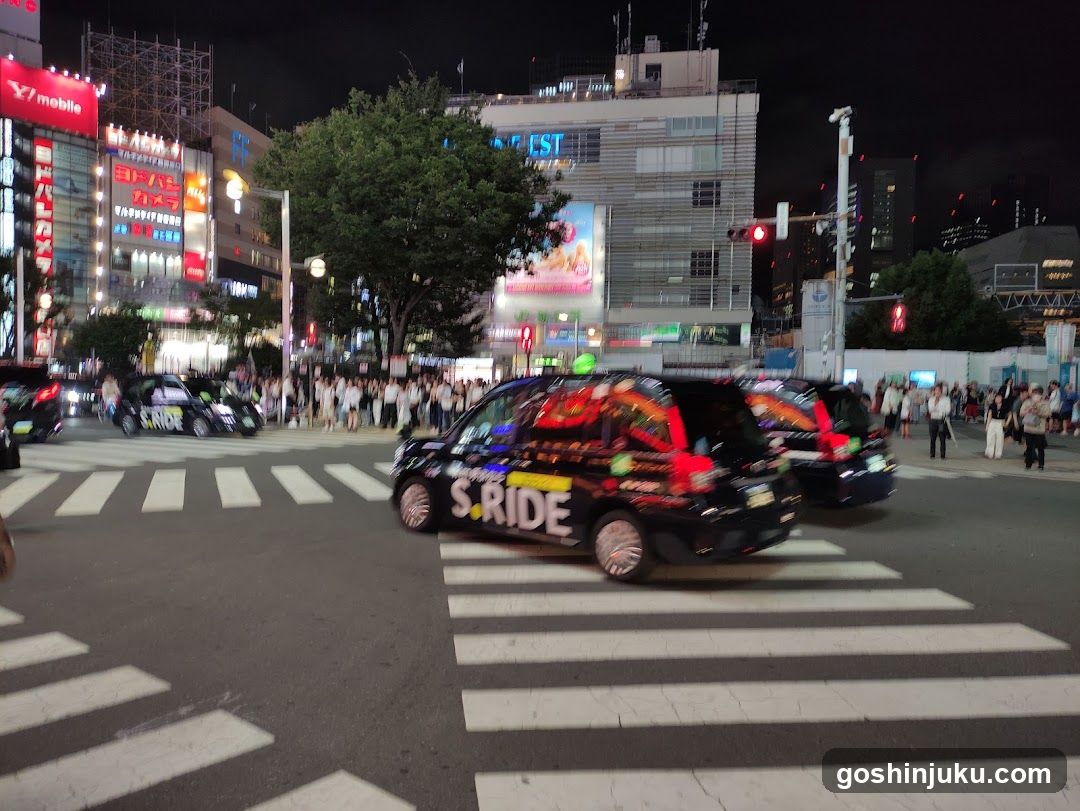 Night street scene with branded vehicles