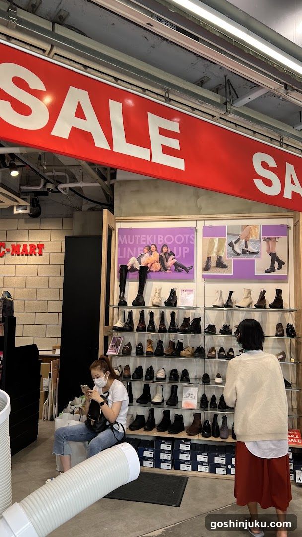 Sale Display with Boots and Shoppers