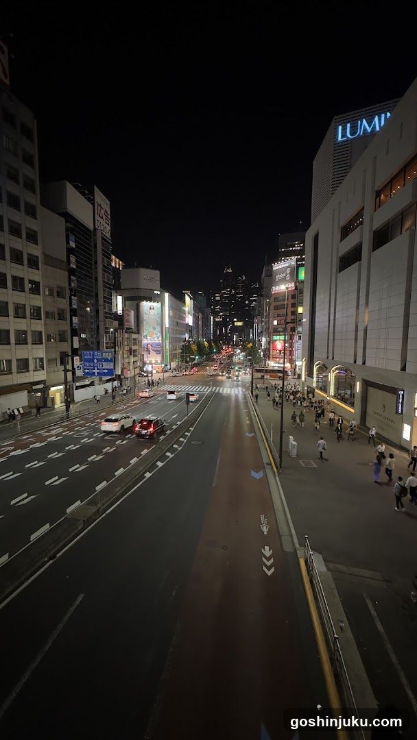 Night street scene with illuminated buildings and traffic