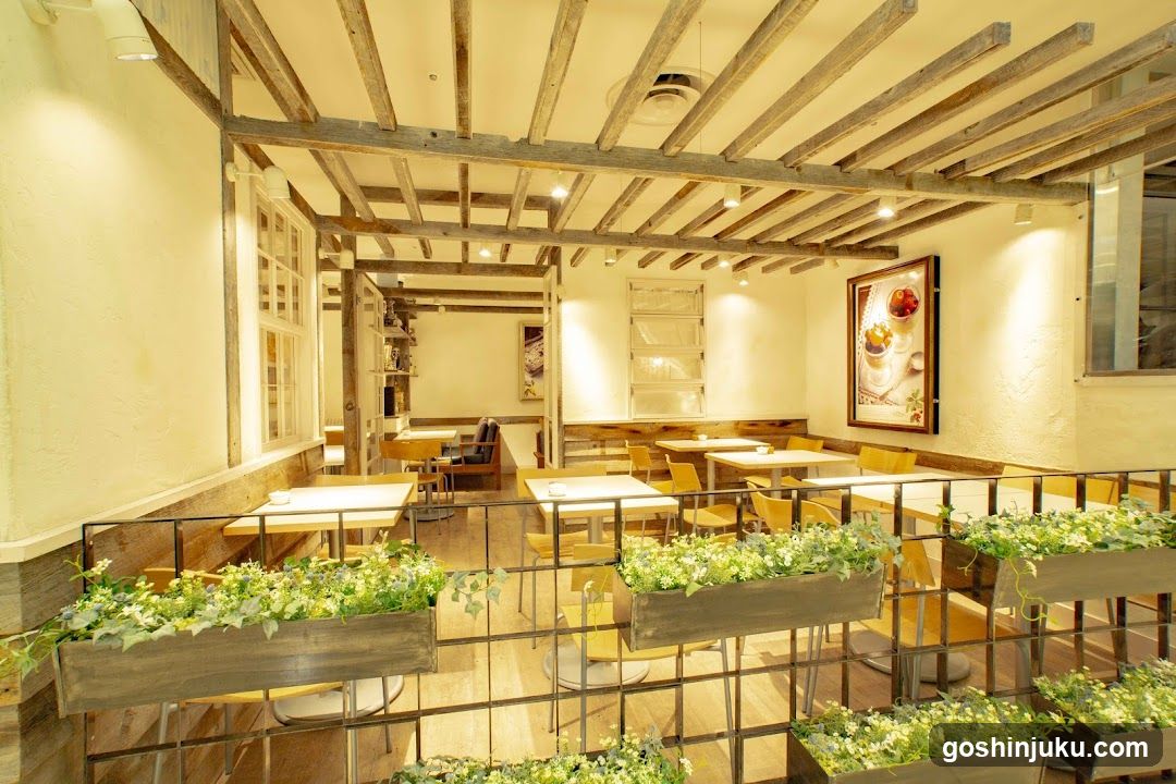 Interior of a cozy cafe with wooden beams and planters