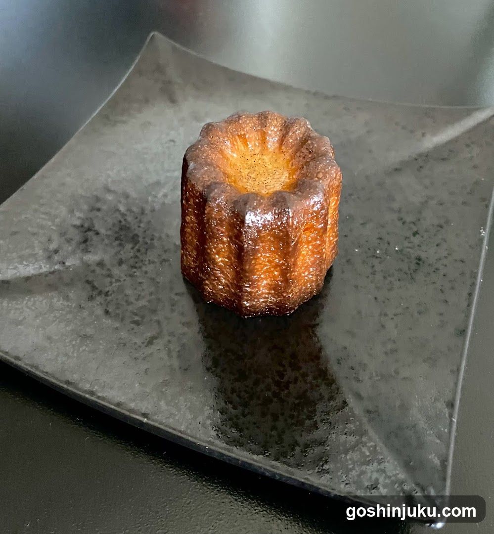 Canelé on a dark plate