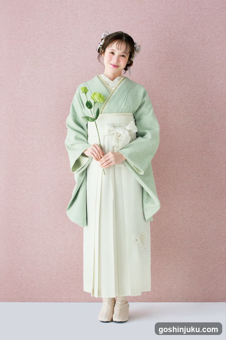 Woman in Traditional Japanese Attire Holding a Flower