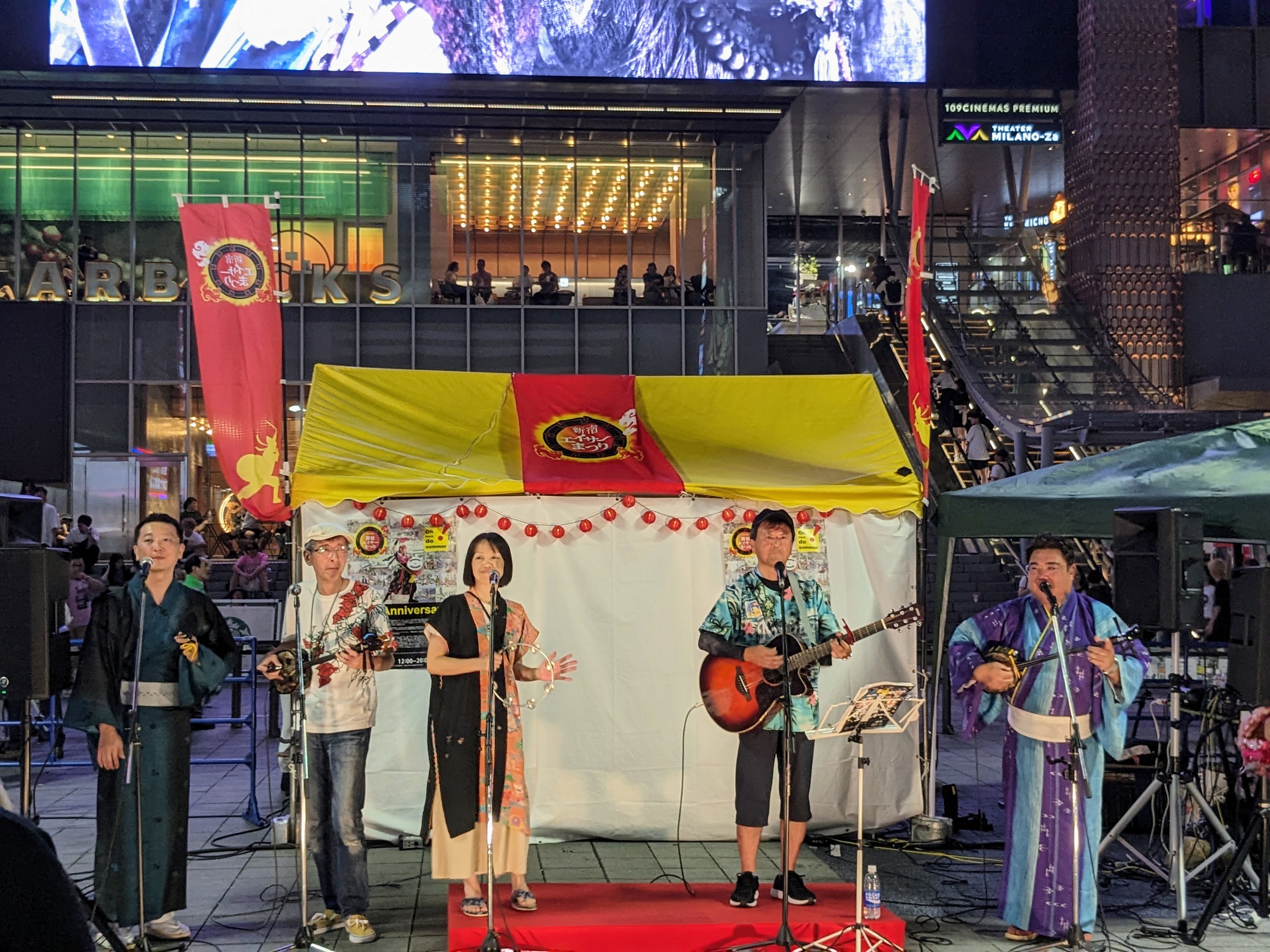 Crowds watching eisa performers with paranku drums along Shinjuku Street during the festival